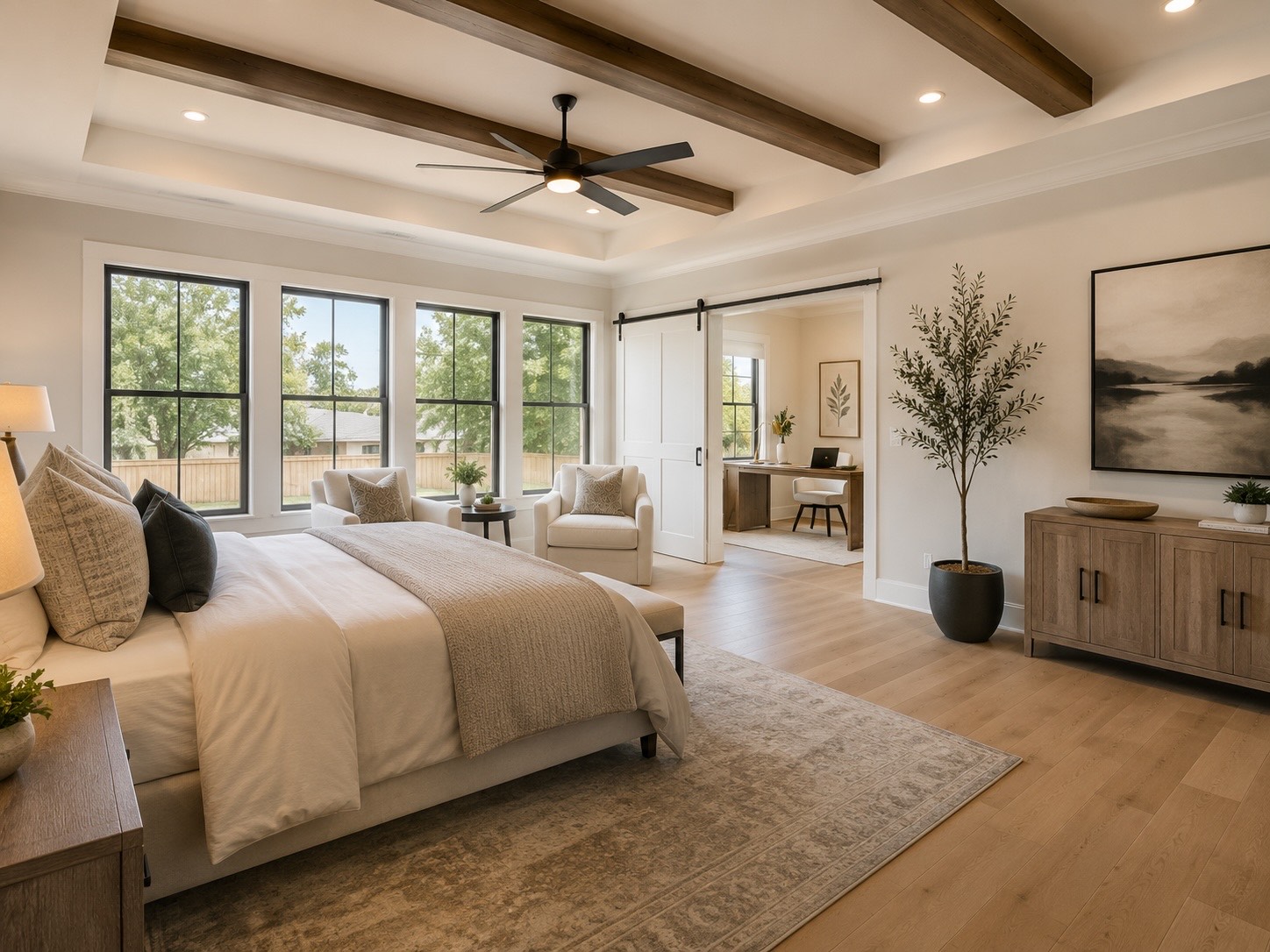 Greater Houston primary-suite addition with coffered ceiling, exposed wood beams, large picture windows, barn-door en-suite entry, and oak hardwood floors